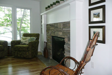 Inspiration for a mid-sized country open concept light wood floor and multicolored floor family room remodel in Other with white walls, a standard fireplace and a stone fireplace