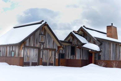 Example of a huge mountain style gray two-story exterior home design in Denver