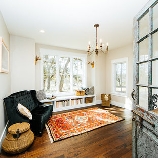 Mid-sized country home office in Austin with a library, bamboo floors, a freestanding desk and brown floor.