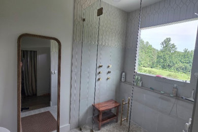 Example of a large french country master beige tile and porcelain tile porcelain tile, beige floor and double-sink bathroom design in Charlotte with beige cabinets, a bidet, beige walls, an undermount sink, quartzite countertops, a hinged shower door, beige countertops and a built-in vanity