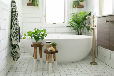 Bathroom - mid-sized mid-century modern master white tile and subway tile porcelain tile and white floor bathroom idea in Minneapolis with flat-panel cabinets, medium tone wood cabinets, a one-piece toilet, white walls, an undermount sink, quartz countertops and a hinged shower door
