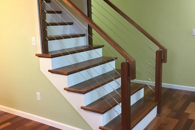 Inspiration for a mid-sized transitional wood straight staircase in Seattle with painted wood risers and mixed railing.