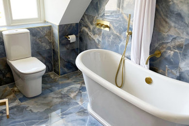 Inspiration for a medium sized traditional family bathroom in Other with a freestanding bath, a shower/bath combination, a one-piece toilet, blue tiles, porcelain tiles, blue walls, porcelain flooring, a console sink, blue floors, a shower curtain, a single sink, a freestanding vanity unit and a drop ceiling.