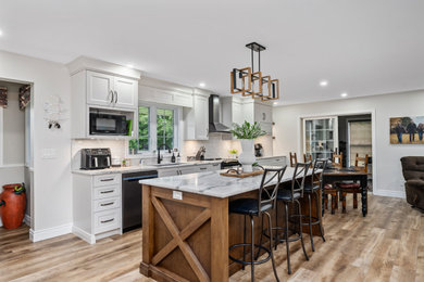 Inspiration for a large farmhouse single-wall beige floor eat-in kitchen remodel in Toronto with shaker cabinets, white cabinets, quartzite countertops, white backsplash, subway tile backsplash, an island and white countertops