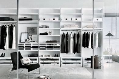 Example of a large trendy gender-neutral gray floor walk-in closet design in Miami with open cabinets and white cabinets