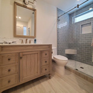Small french country porcelain tile porcelain tile, beige floor and single-sink bathroom photo in Orange County with beaded inset cabinets, medium tone wood cabinets, a one-piece toilet, an undermount sink, quartz countertops, white countertops and a freestanding vanity