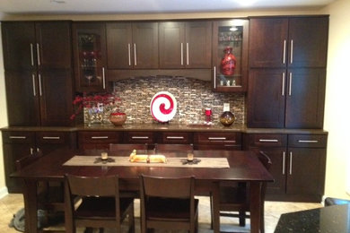 Kitchen in DC Metro with beige splashback, stainless steel appliances and with island.