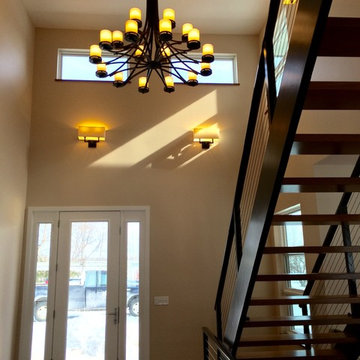 Modern Prairie Style Home Foyer with open stairway.