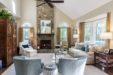 Large transitional open concept medium tone wood floor and brown floor family room photo in DC Metro with beige walls, a standard fireplace and a stone fireplace