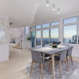 Inspiration for a large contemporary open plan dining in Perth with white walls, light hardwood floors and beige floor.