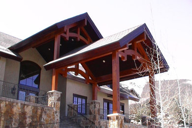 Large arts and crafts beige two-story stucco exterior home photo in Salt Lake City with a shingle roof