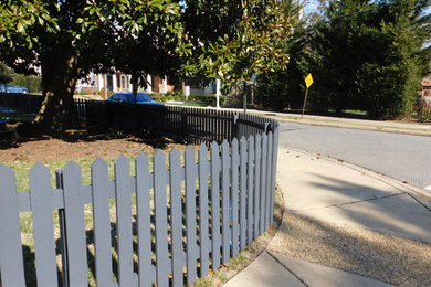 Curved painted cedar picket fence
