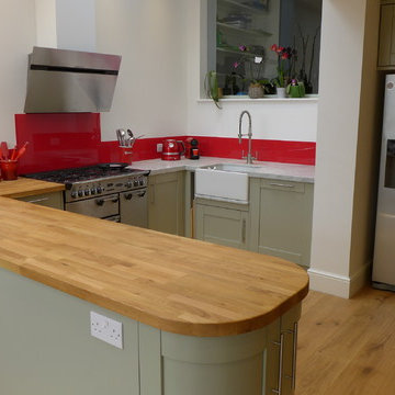Pale Green Shaker Kitchen with Red Glass Splashback