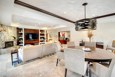 Example of a mid-sized trendy open concept ceramic tile living room design in Orange County with white walls and no fireplace