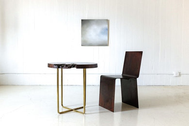 Vignette of Walnut and Brass Table, Patinated Steel Chair and Oil on Wood Painti