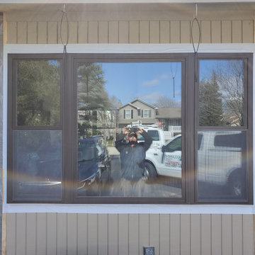 Bronze 25/50/25 vinyl replacement window unit before new siding