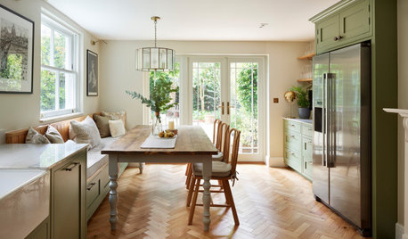 Sunlight Streams Into an Elegant Green-and-Wood Kitchen