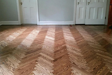 Elegant medium tone wood floor and brown floor living room photo in St Louis with gray walls