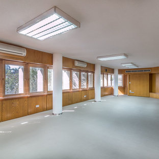 Inspiration for a large modern home office and library in London with white walls and vinyl flooring.