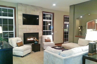 Example of a mid-sized transitional enclosed carpeted living room design in Other with green walls, a standard fireplace, a tile fireplace and a media wall