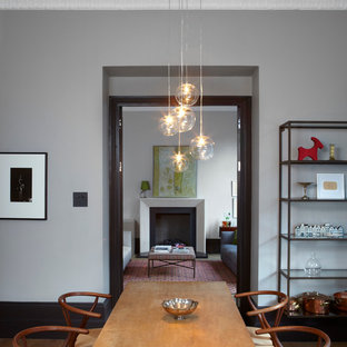 This is an example of a modern dining room in London with grey walls.