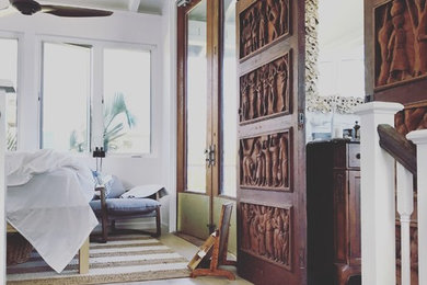 Mid-sized island style master light wood floor and beige floor bedroom photo in Hawaii with white walls and no fireplace