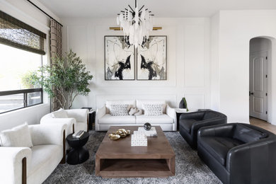 Living room - mid-sized modern open concept light wood floor, beige floor and wall paneling living room idea in Phoenix with white walls, no fireplace and a wall-mounted tv