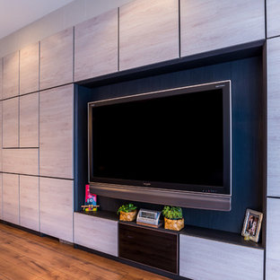 Photo of a large world-inspired open plan home cinema in Other with white walls, plywood flooring, a wall mounted tv and brown floors.