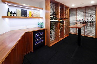Design ideas for an expansive wine cellar in Sydney with storage racks and black floor.