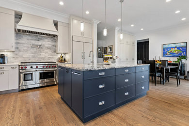 Example of a large transitional l-shaped open concept kitchen design in Chicago with flat-panel cabinets, white cabinets, granite countertops and two islands
