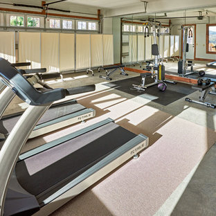 Design ideas for a small modern multi-use home gym in Charlotte with beige walls and concrete flooring.