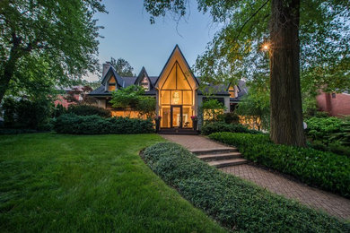 Large transitional beige two-story stucco exterior home idea in Other with a shingle roof