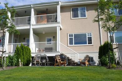 Example of a mid-sized classic backyard deck design in Vancouver with a roof extension