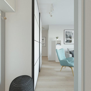 This is an example of a small scandinavian open plan living room in Other with grey walls, laminate floors, a wall mounted tv and pink floors.
