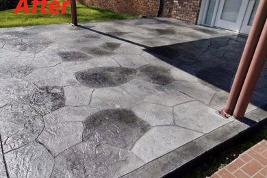 Mid-sized backyard stamped concrete patio photo in Other