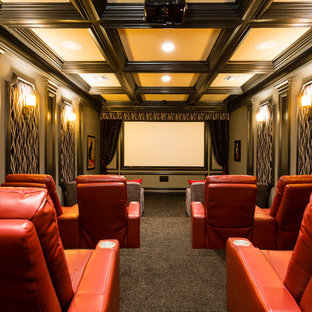 This is an example of a classic enclosed home cinema in Orlando with carpet, a projector screen and grey floors.