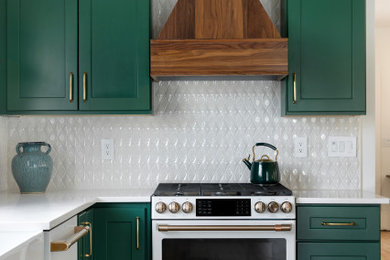 Inspiration for a large transitional light wood floor and exposed beam kitchen remodel in Minneapolis with a farmhouse sink, shaker cabinets, green cabinets, quartz countertops, white backsplash, ceramic backsplash, white appliances, a peninsula and white countertops
