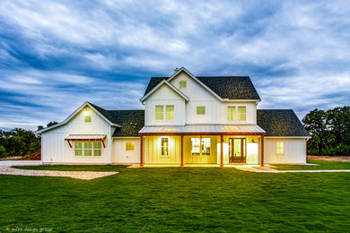 Inspiration for a mid-sized cottage white two-story concrete fiberboard exterior home remodel in Austin with a mixed material roof