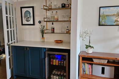 Example of a mid-century modern dry bar design in Toronto with shaker cabinets, blue cabinets, quartzite countertops and blue countertops
