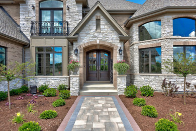 Elegant entryway photo in Chicago with a dark wood front door
