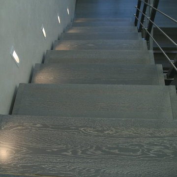 Modern metal stair covered by patina oak
