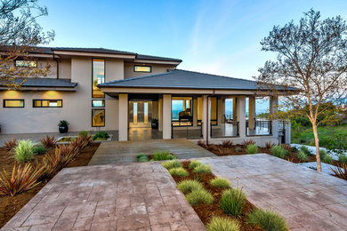 Mid-sized minimalist beige two-story stucco exterior home photo in San Francisco with a hip roof