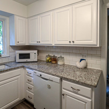 White Kitchen with Granite Countertop and New Flooring