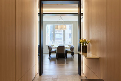 Hallway - mid-sized contemporary ceramic tile, beige floor and wall paneling hallway idea in New York