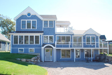Inspiration for a large coastal blue three-story wood and shingle exterior home remodel in Providence