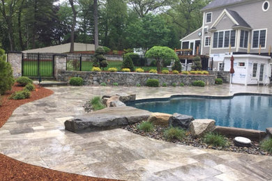Large trendy backyard stone lap pool photo