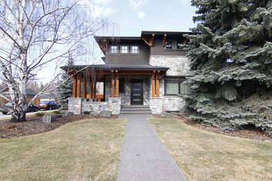 Mid-sized contemporary brown two-story stone exterior home idea in Calgary