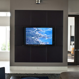 This is an example of a contemporary home cinema in Tampa with a wall mounted tv.