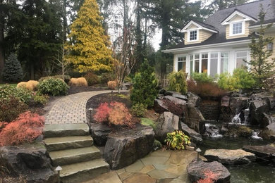 Inspiration for a large arts and crafts backyard full sun garden in Portland with a garden path and concrete pavers.