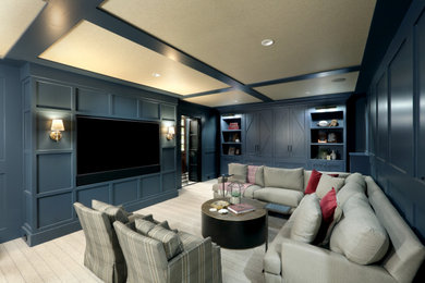 Example of a mid-sized classic carpeted, wallpaper ceiling and wall paneling basement design in Grand Rapids with blue walls, a hanging fireplace and a wood fireplace surround